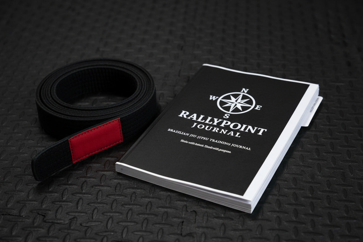Black notebook with 'Rallypoint Journal' logo and text on a white background