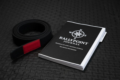 Black notebook with 'Rallypoint Journal' logo and text on a white background